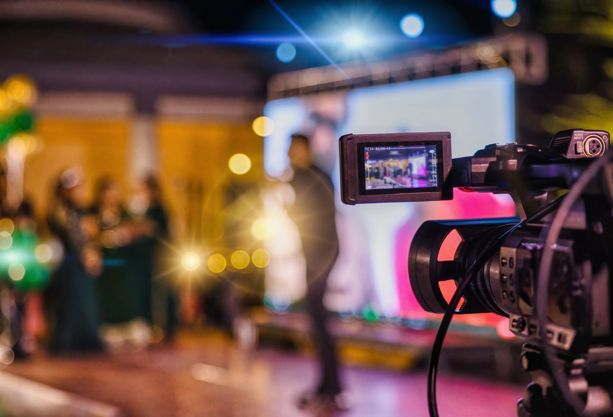 POV camcorder filming a stage with lights.